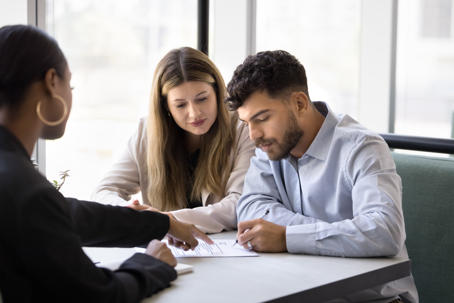 Couple signing documents | Alex & LaFleur, Attorneys at Law